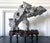 A stunning Taihu scholar stone in an unusual horizonal balanced form perched on a custom wood stand. The stone, in a...
