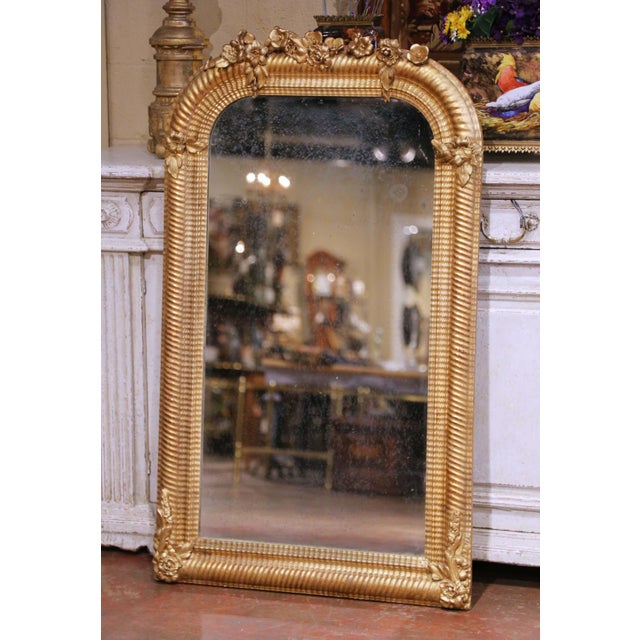 This elegant antique giltwood mirror was crafted in France circa 1870 and reflects the refined proportions of the Louis...