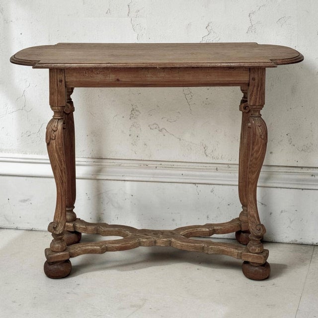 A beautiful 18th century Country French oak side table with a wonderfully aged surface, elegant carved base and remarkable...