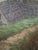 A striking large-scale antique European landscape painting depicting a sweeping pastoral countryside dotted with rustic...