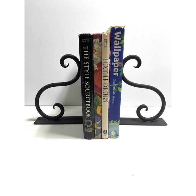 A beautiful pair of vintage wrought iron bookends featuring elegant scrollwork and classic architectural lines. Their...
