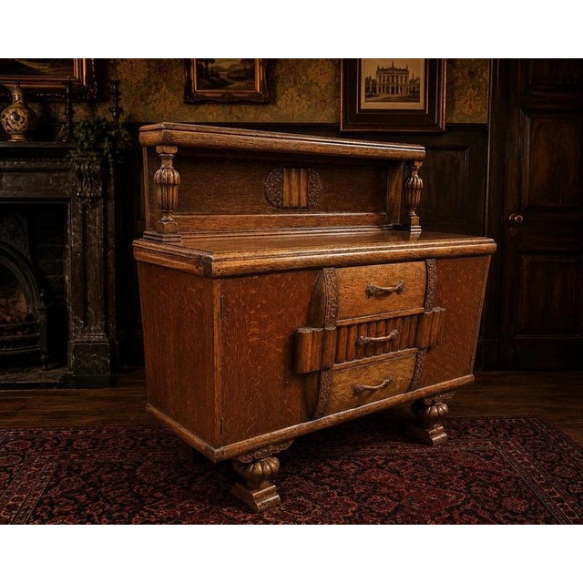 An exceptional and highly unusual english art deco solid oak sideboard dating to the 1930s, retaining its original...