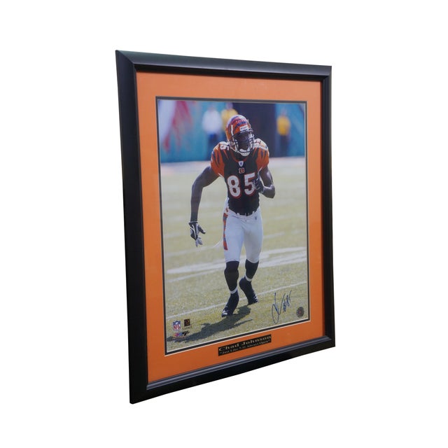 Vintage framed, autographed photo of former Cincinnati Bengals wide receiver Chad Johnson Ochocinco, featuring an orange...