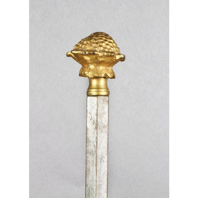 Cast floral finial with steel stem supporting an adjustable dark green tole shade and two lights , lower adjustable candle...