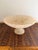 A beautifully carved vintage marble compote bowl featuring a delicate scalloped rim and classic pedestal base. The stone...