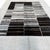 A striking contemporary rug crafted from reclaimed hemp and goat wool, featuring a bold abstract design of black linear...