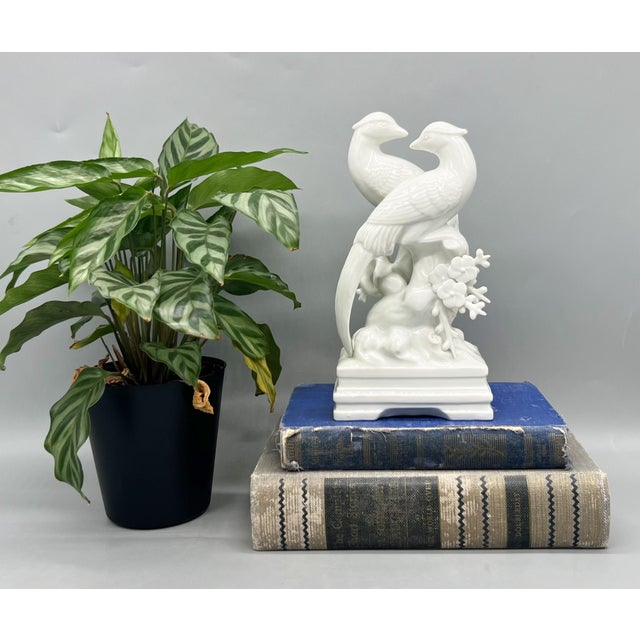 Stunning Chinoiserie-style bird figurine by Fitz and Floyd, crafted in glossy white ceramic and dated 1979. This...