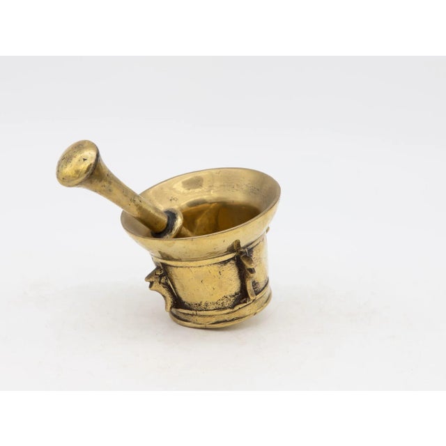 This early 20th-century mortar and pestle is made of brass with an honest patina. Both the mortar and pestle are...
