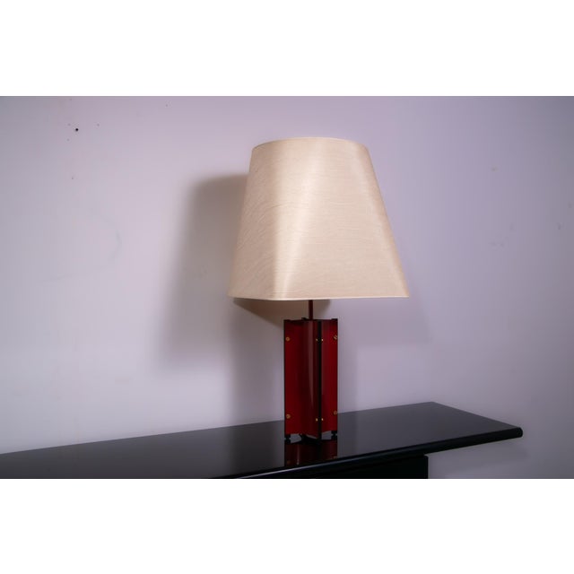 Laquered red sculptural metal tabl;e lamp with oversized lamp shade. European Plug (up to 250V).The wiring of this item...