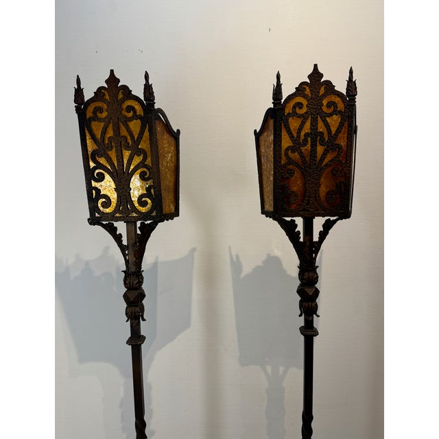 Elevate your space with this stunning pair of vintage wrought iron floor lamps, featuring intricately designed bases and...