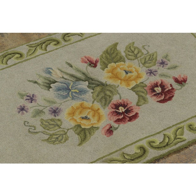 This antique 2x3 hooked gift rug, circa 1920–1929, features a graceful floral bouquet rendered in soft yellow, blue, and...