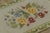This antique 2x3 hooked gift rug, circa 1920–1929, features a graceful floral bouquet rendered in soft yellow, blue, and...