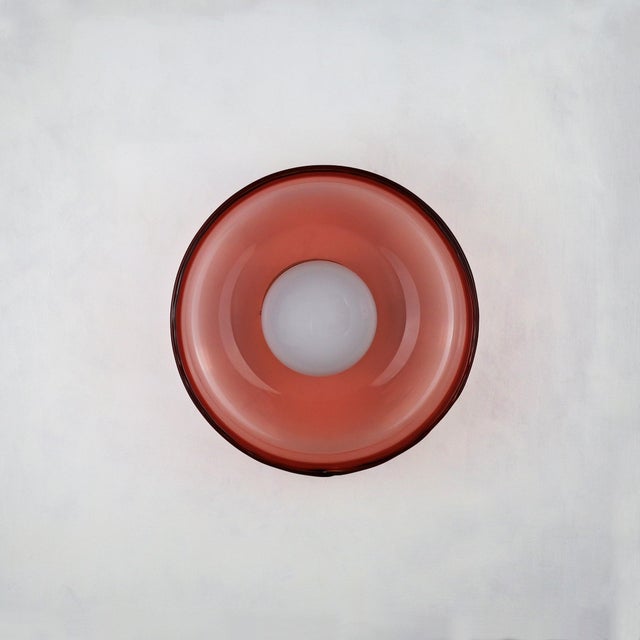 This small wall light is crafted from hand-blown glass, offering a delicate yet expressive presence. Its compact scale...