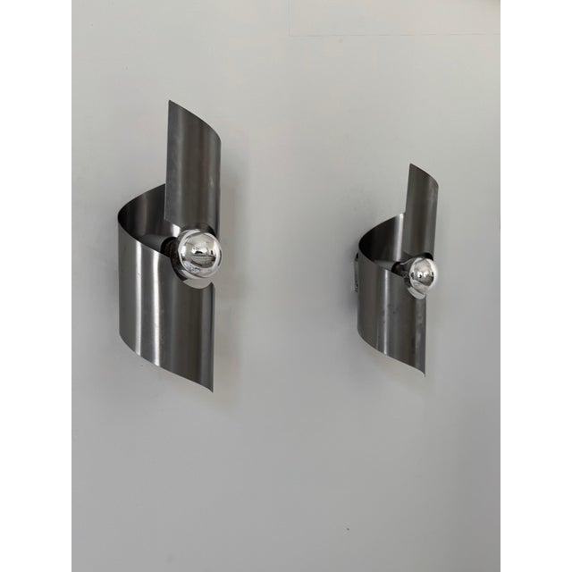 Pair of wall sconces with a brushed metal frame, produced in France in the 1970s. Timeless design typical of the 1970s,...