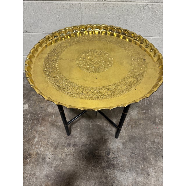Sweet little brass tray drink or coffee table with faux bamboo painted black folding base. Sturdy. Table base has suction...