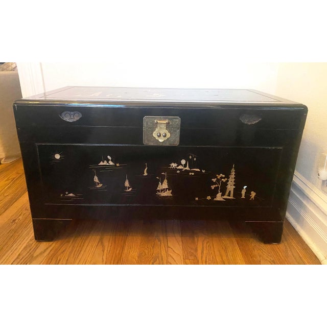 Vintage Black Lacquer Chinoiserie Wedding Chest With Mother of Pearl Inlay mid - late 20th c. The mother of pearl scenes...