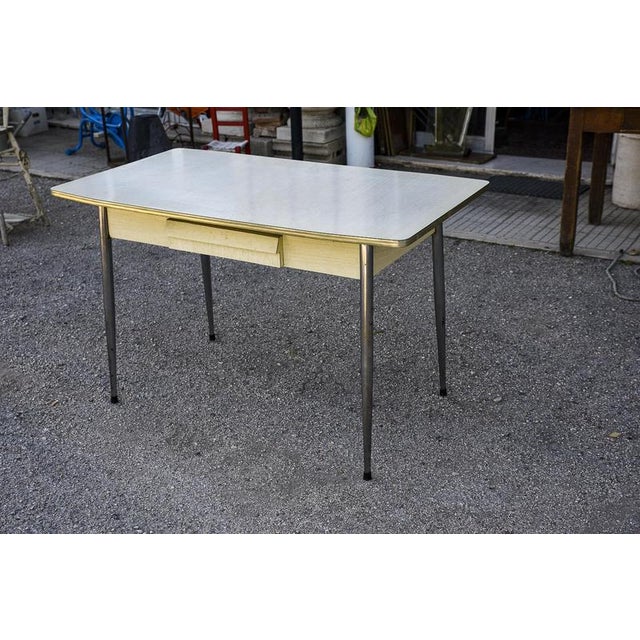 Kitchen table with white formica top edged in metal, central drawer and pastry board for making homemade pasta. Chromed...