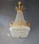 Introducing a stunning Brass Basket Empire Sac a Pearl Chandelier, an exquisite piece adorned with captivating crystals,...