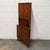 A vintage Danish teak corner cabinet from the 1960s with a tall, narrow form designed to make good use of a room’s corner....