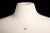 An elegant 14K gold chain necklace featuring an emerald cut center pendant with four round, brilliant cut diamonds on all...
