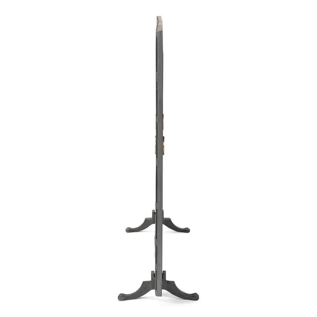 dark grey iron paneled fireplace screen with X frame panels centered with gold rosettes and raised on paw feet. DIMENSIONS...