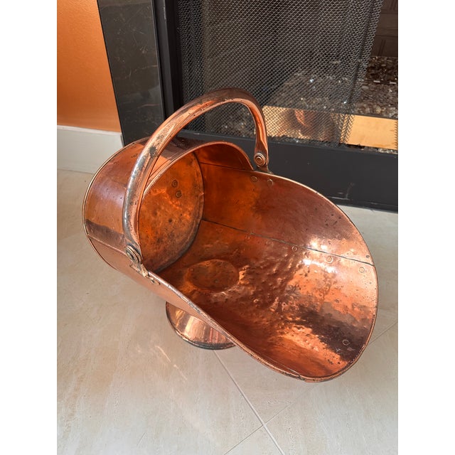 An impressive antique Victorian copper helmet-form coal scuttle, dating to the 19th century, with a graceful sweeping...