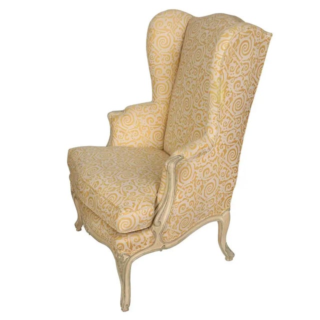 A handsome Louis XV-style wingback chair featuring a gracefully shaped silhouette and classic French-inspired detailing....
