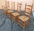A set of 4 (1 captain and 3 sides) rush seated ladder back chairs from W F Whitney. circa 1920's. These chairs have a...