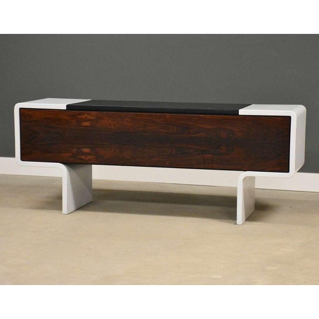A mid century modern space age sideboard credenza constructed of a molded fiberglass frame and rosewood doors designed by...