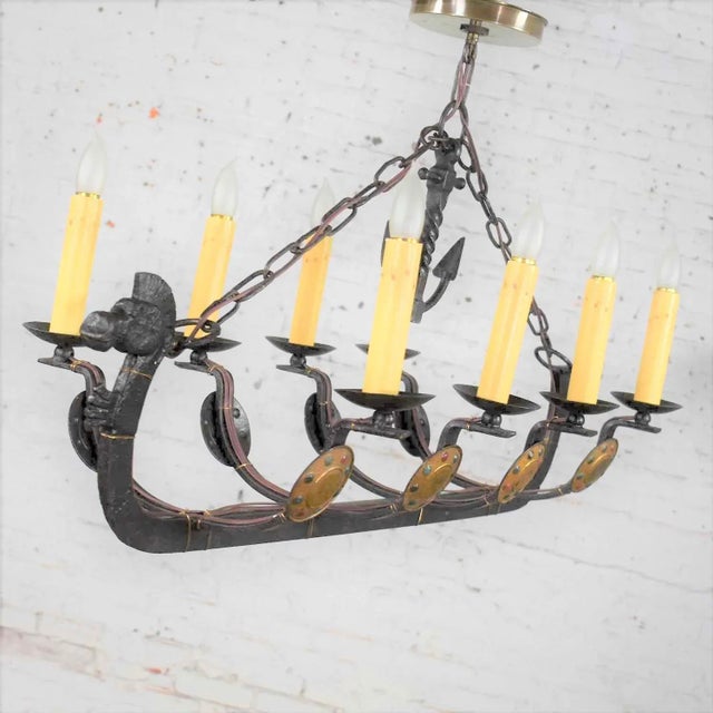 Handsome and unusual cast iron eight light chandelier in the shape of a Viking longboat or ship with a horse head, horse...