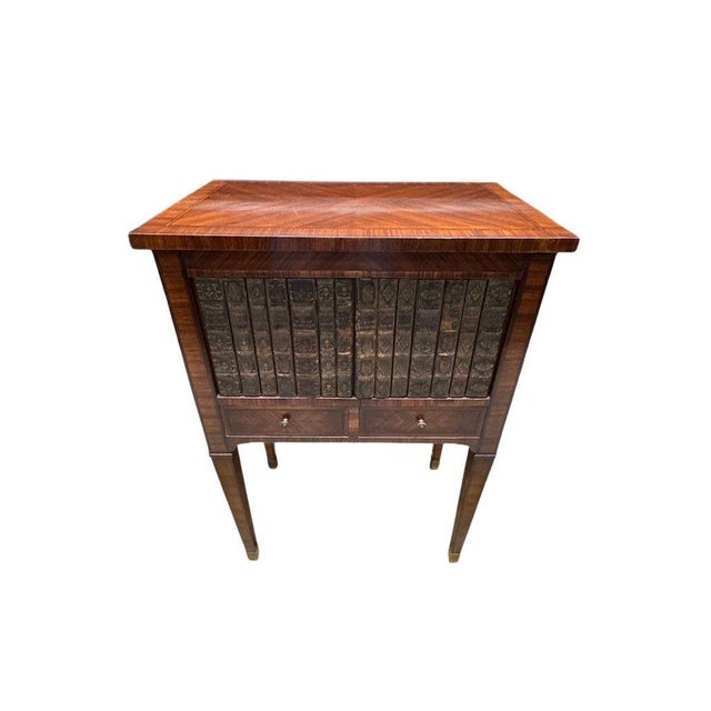A wonderfully distinctive antique French cabinet dating to the late 19th century, featuring exquisite marquetry detailing,...