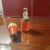 Antique French travel perfume or cologne bottle. The painted metal case has a spring loaded lid with a cork that keeps the...