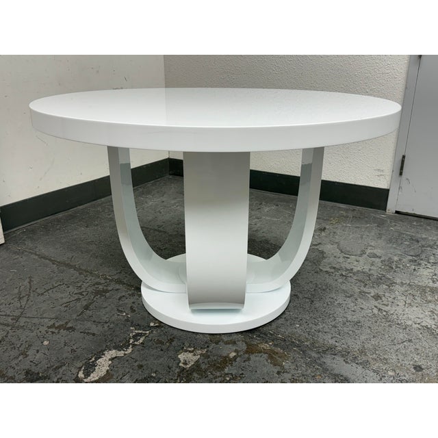 Design Plus Gallery presents a Custom Made Entry Table with Pedestal Base. The table has a white as can be lacquered...