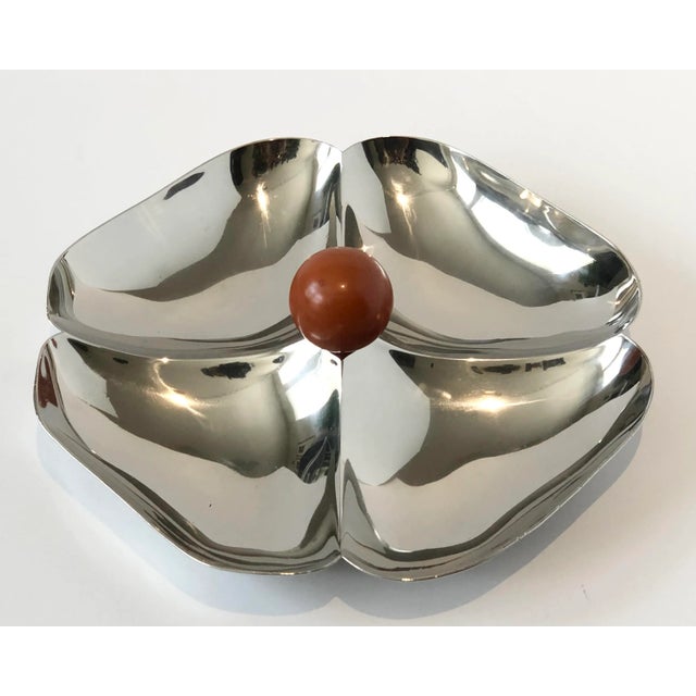 Mid-Century Modern chrome candy dish/serving piece in the form of a flower pattern, with a caramel color round knob. Circa...