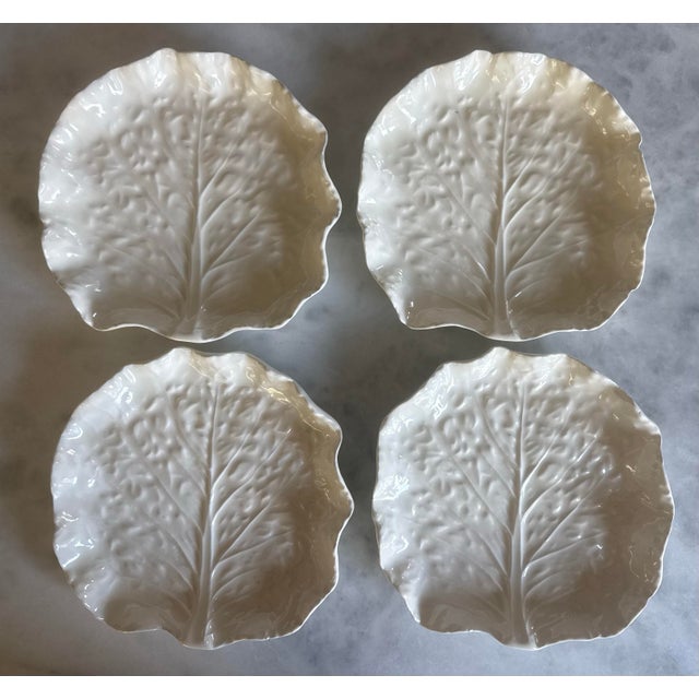 Set of 4 white ceramic cabbage leaf plates in the style of Bordallo Pinheiro, featuring textured vein details and ruffled...