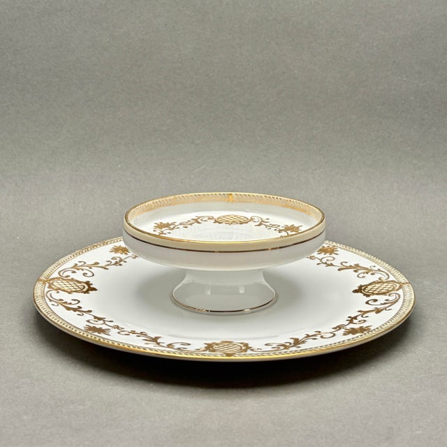 This elegant vintage porcelain tiered tidbit tray features beautiful hand-painted gold filigree, floral accents, and...