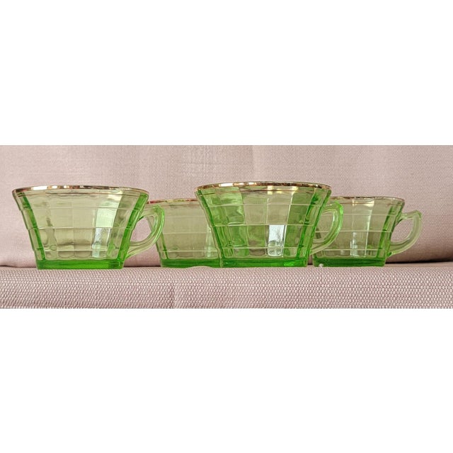 Set of 4 Transparent Green Uranium Glass Tea Cups with gold plate rim In very nice condition but the gold is rubbed off a...