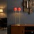 Gilded bronze sculpture lamp with two lights and a red fabric lampshade. This piece is attributed to the mentioned...