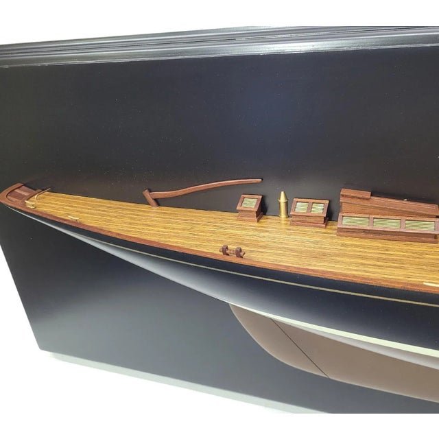 Scale half model of the British Royal racing yacht “Britannia”. Large model with hull painted black over bronze. Planked...