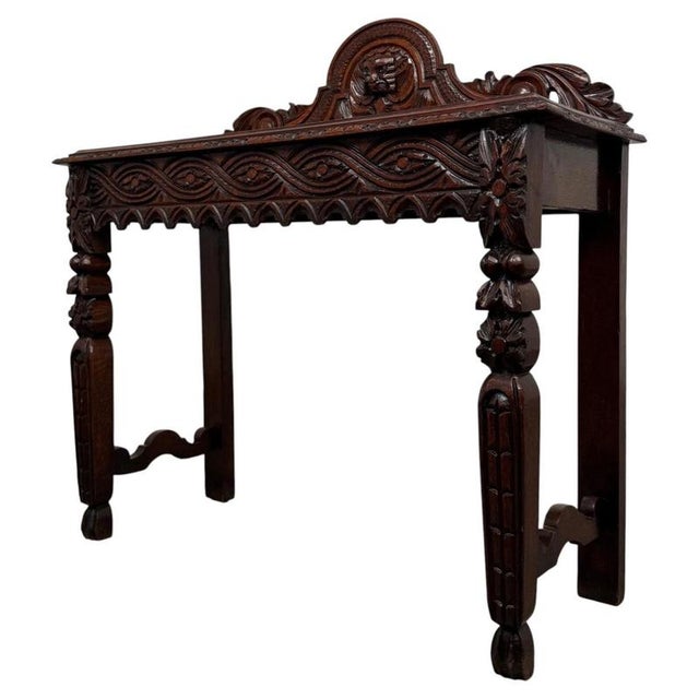 A handsome and highly decorative 19th-century English Victorian side table, beautifully crafted in richly grained oak and...