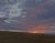 "First Light" is an oil on mounted linen landscape painting by Michael Magrin, completed in 2025. Heavy gray violet clouds...