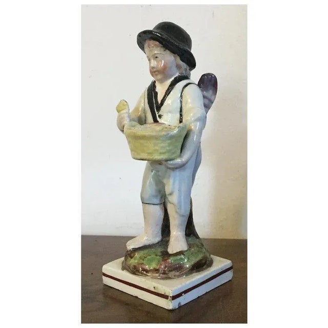 Antique early 19th c. English George III Staffordshire pearlware figure of a bread seller with angel wings. Measures 6...
