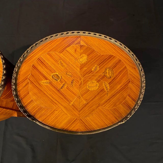 Elegant pair of French Louis XV side / end tables, bedside tables or nightstands with exquisite marquetry. Classic pair of...