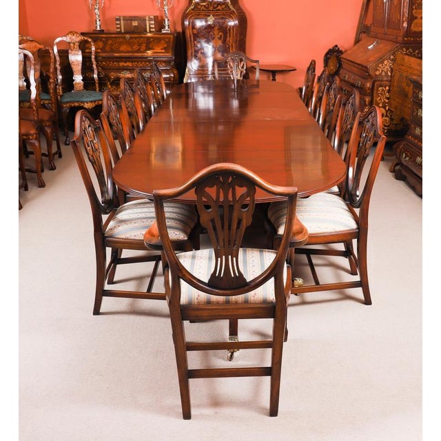 This is an elegant dining set comprising an antique late Victorian three pillar Regency Revival flame mahogany dining...