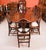 This is an elegant dining set comprising an antique late Victorian three pillar Regency Revival flame mahogany dining...