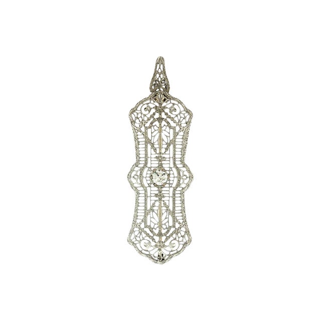 An exquisite 1930's depression filigree platinum and 14k gold brooch. This piece features intricate filigree work,...