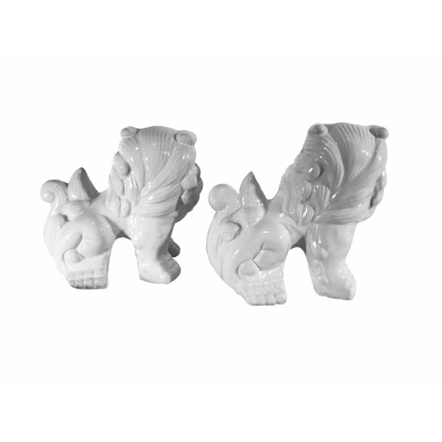 Pair of vintage, white ceramic Foo Dogs, drenched in a high gloss glaze. These two pieces embody great character and detail!