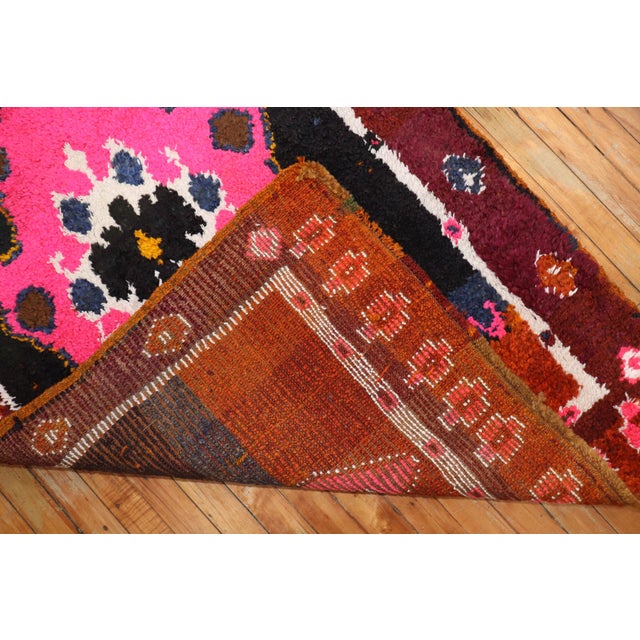 A long wool pile Turkish runner with saturated colors featuring an intense pink color we seldom find in vintage rugs. This...