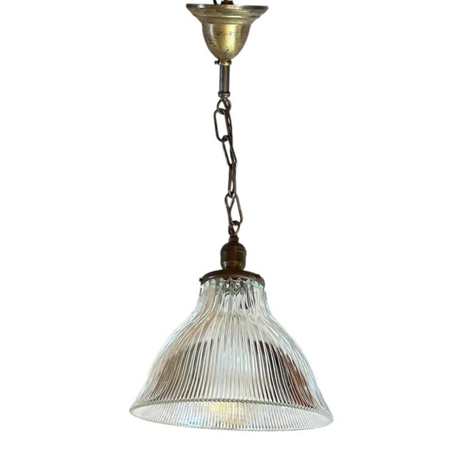 This is really a pretty piece of glass hanging on the original patina brass holder. Fabulous light even when its not...