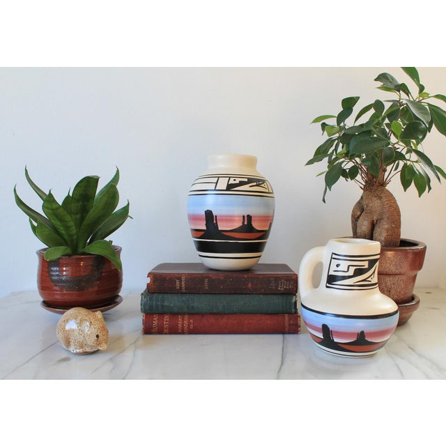 Vintage hand painted Native American Navajo Naattsilid pottery vase and pitcher. Both are signed by the artist. Vase...